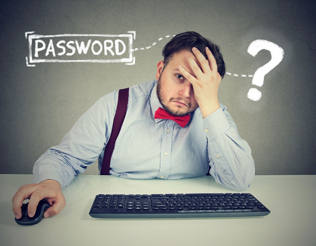 Man in front of computer trying to remember his password