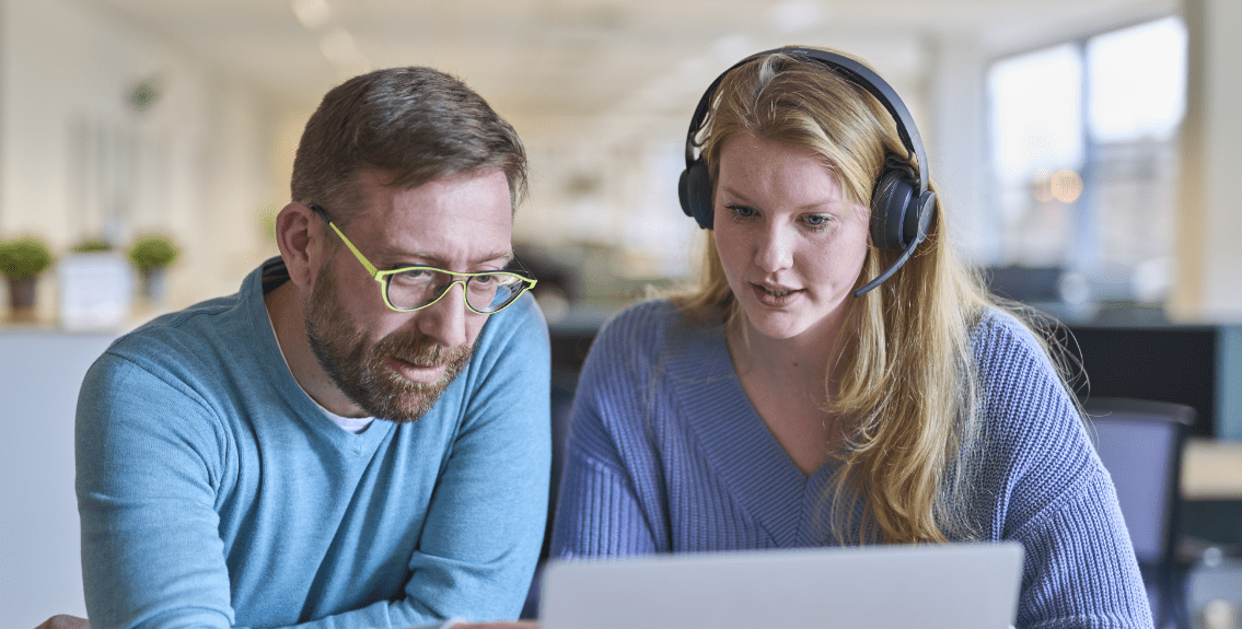 customer support agents in front of laptop